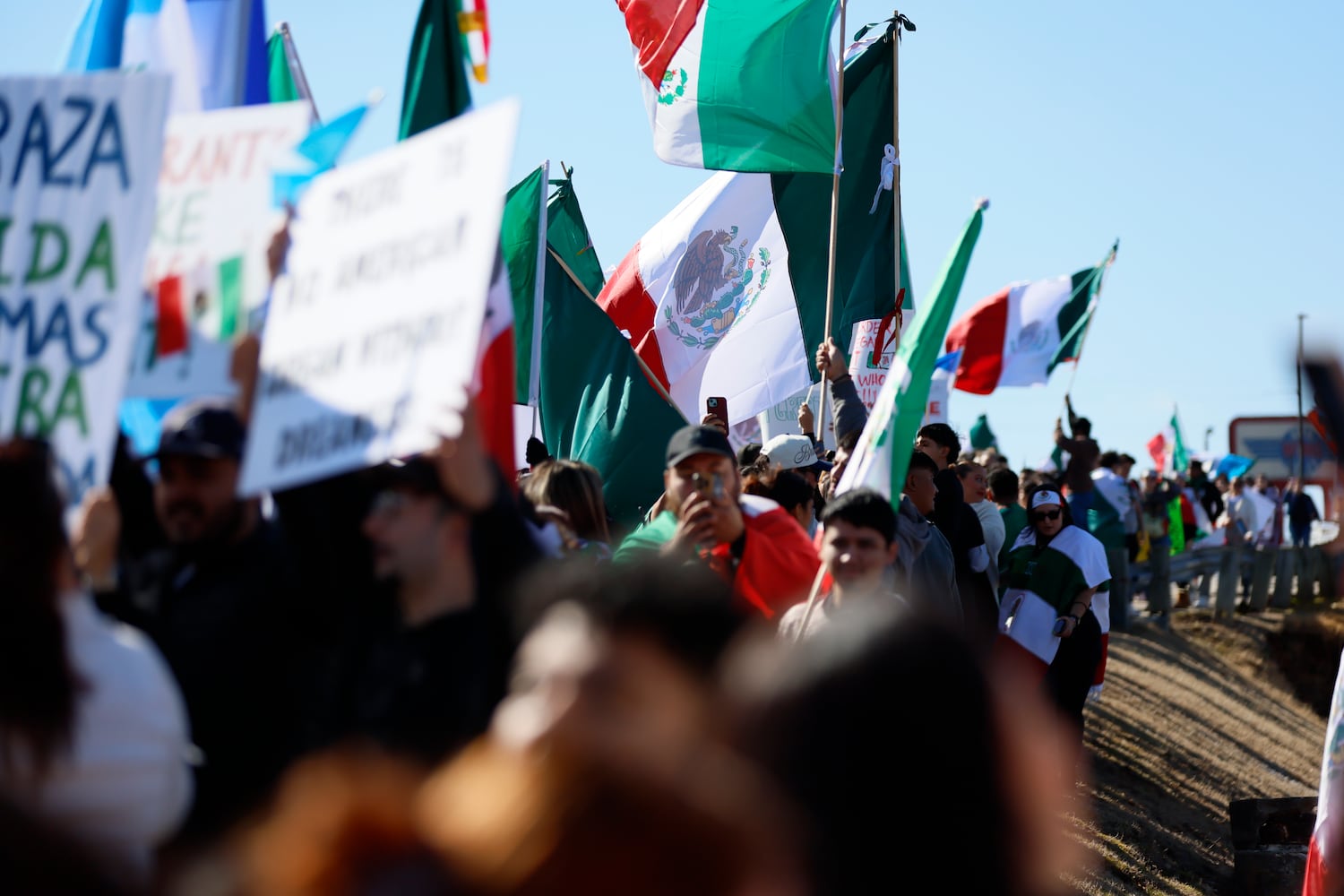 Pro-immigrant protesters gathered on Buford Highway as they waved Latin-American flags near Plaza Fiesta on Saturday, Feb. 1, 2025, to demonstrate in response to a recent immigration arrest in Georgia. 
(Miguel Martinez/ AJC)