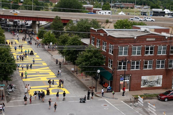 People walk along Greenwood Avenue on Friday in Tulsa, Oklahoma, where the words "Black Lives Matter" were painted on the road as people mark Juneteenth.