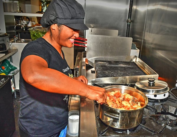 At the Estrellita restaurant in Grant Park, chef Blesseda Gamble (sister of co-owner Walter Cortado) prepares a dish they grew up with, called Afritada, a Filipino dish of a whole chicken cut up, with potatoes, peppers, tomatoes, garlic and onion served over jasmine rice. Chris Hunt for The Atlanta Journal-Constitution