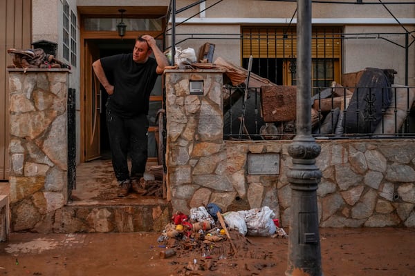 A man reacts in his house affected by floods in Utiel, Spain, Wednesday, Oct. 30, 2024. (AP Photo/Manu Fernandez)