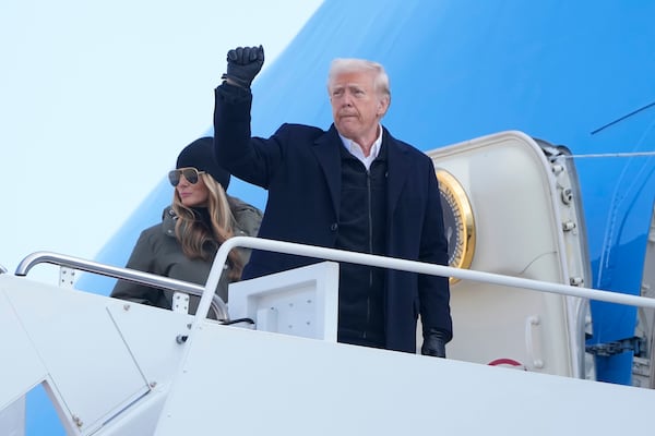 President Donald Trump and first lady Melania Trump board Air Force One, Friday, Jan. 24, 2025, at Joint Base Andrews, Md., for a trip to North Carolina and California. (AP Photo/Mark Schiefelbein)