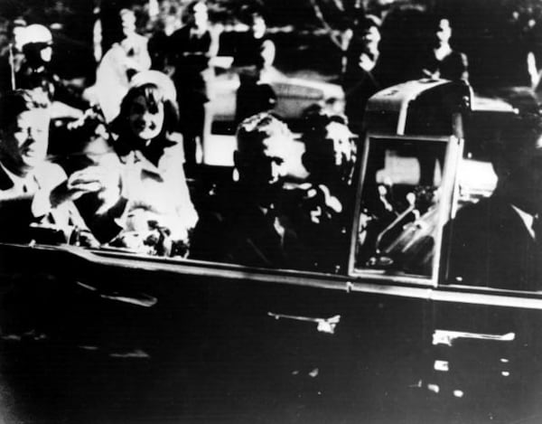 President John F. Kennedy (1917 - 1963) and his wife Jacqueline Kennedy ride with secret agents in an open car motorcade shortly before the president was assassinated in Dallas, Texas, November 22, 1963. (Photo by Keystone/Getty Images)