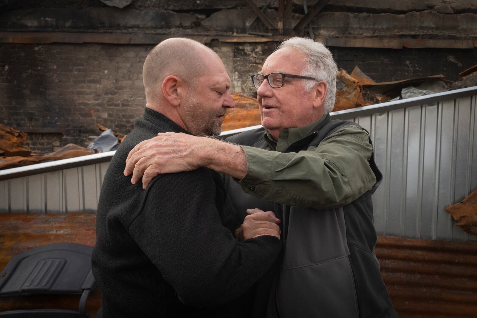 U.S. philanthropist Howard G. Buffett supports a local resident who lost his son in a Russian missile attack in Kharkiv region, Ukraine, Monday, Oct. 28, 2024. (AP Photo/Efrem Lukatsky)