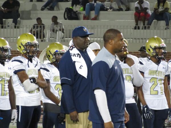 Winston Gordon (center, hat) has coached the Hornets since the program's inaugural season in 2011. (Adam Krohn)