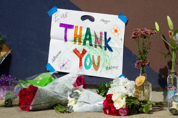 People left flowers and notes under the large John Lewis mural on Auburn Ave, July 18, 2020. STEVE SCHAEFER FOR THE ATLANTA JOURNAL-CONSTITUTION