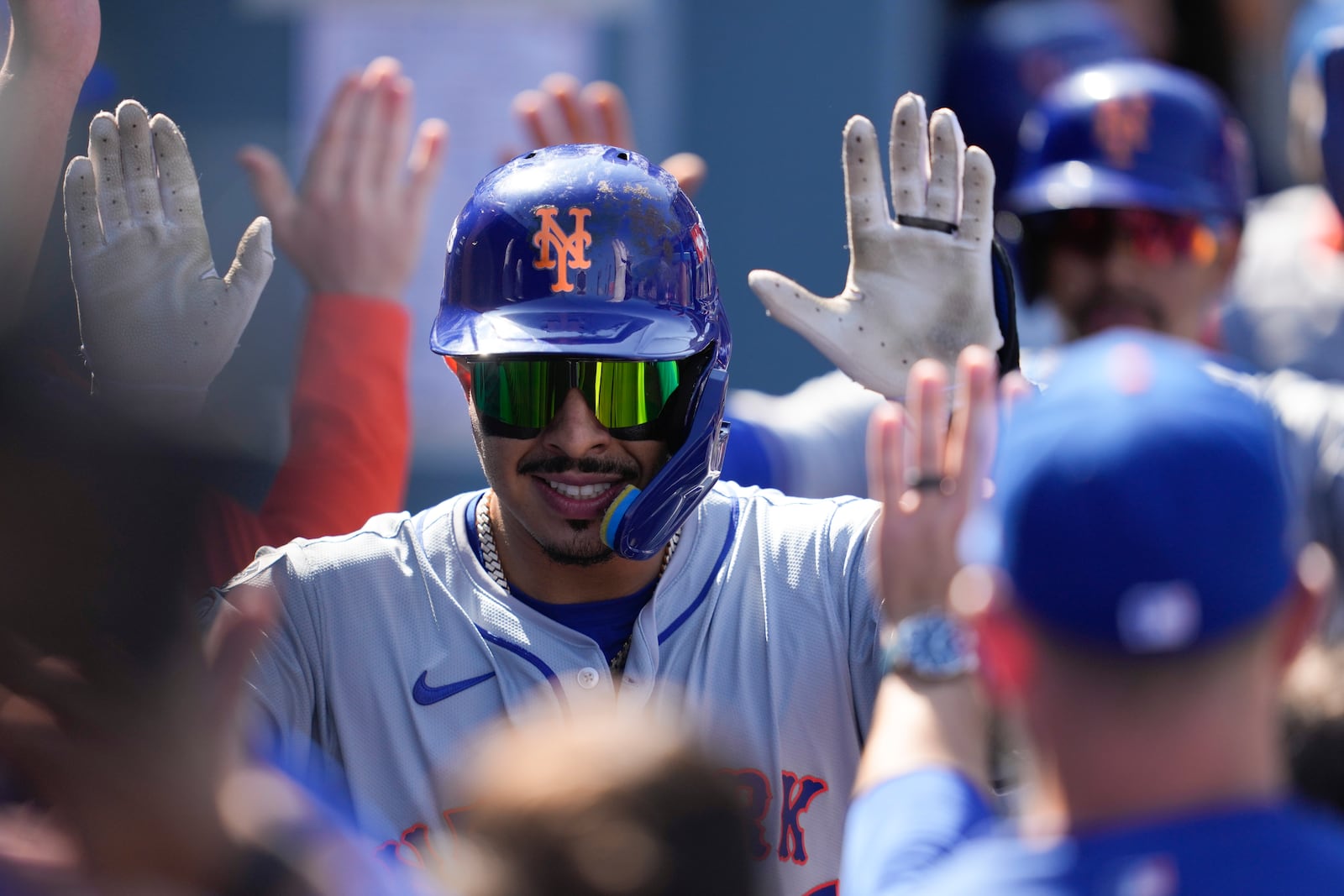 New York Mets' Mark Vientos celebrates in the dugout after his grand slam home run against the Los Angeles Dodgers during the second inning in Game 2 of a baseball NL Championship Series, Monday, Oct. 14, 2024, in Los Angeles. (AP Photo/Ashley Landis)