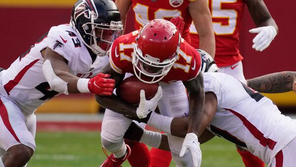 Kansas City Chiefs wide receiver Mecole Hardman is tackled by Atlanta Falcons Mykal Walker, left, and Sharrod Neasman during the second half Sunday, Dec. 27, 2020, in Kansas City, Mo. (Charlie Riedel/AP)