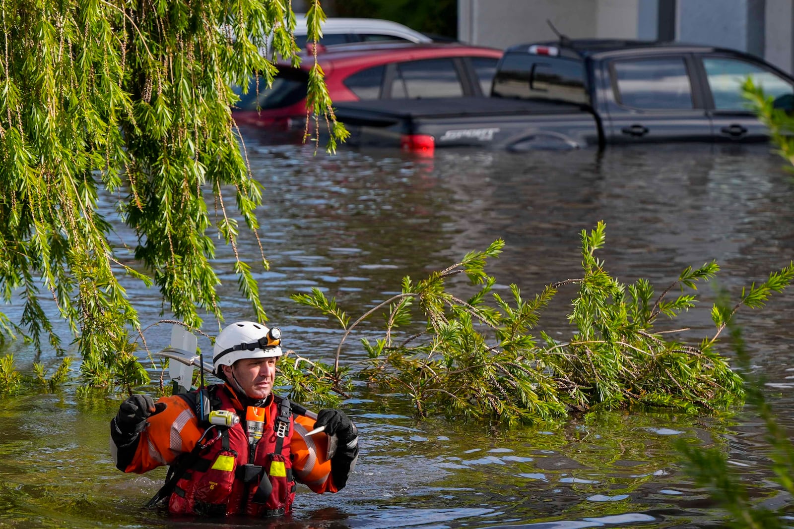 A water rescue team member walks through flood waters at an apartment complex in the aftermath of Hurricane Milton, Thursday, Oct. 10, 2024, in Clearwater, Fla. (AP Photo/Mike Stewart)