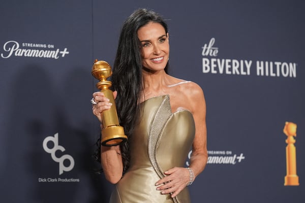 Demi Moore poses in the press room with the award for best performance by a female actor in a motion picture - musical or comedy for "The Substance" during the 82nd Golden Globes on Sunday, Jan. 5, 2025, at the Beverly Hilton in Beverly Hills, Calif. (AP Photo/Chris Pizzello)