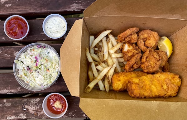 The Admiral Platter at Big B's Fish Joint features battered and fried cod, shrimp and scallops with Old Bay french fries, coleslaw and house-made tartar and cocktail sauces. Ligaya Figueras/ligaya.figueras@ajc.com