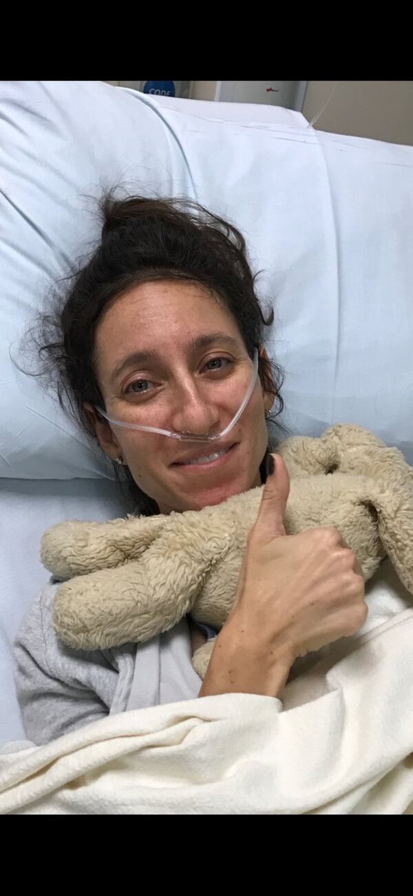 Emily Moore gives a thumbs-up after completing surgery at St. Joseph’s Hospital in Atlanta. CONTRIBUTED