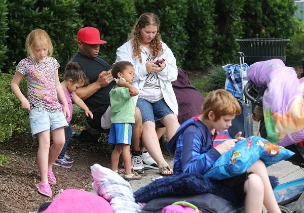 William Lavelle Daniels, his wife April, and their children join hundreds of other local residents being evacuated from the city at the Savannah Civic Center Saturday.  Curtis Compton/ccompton@ajc.com