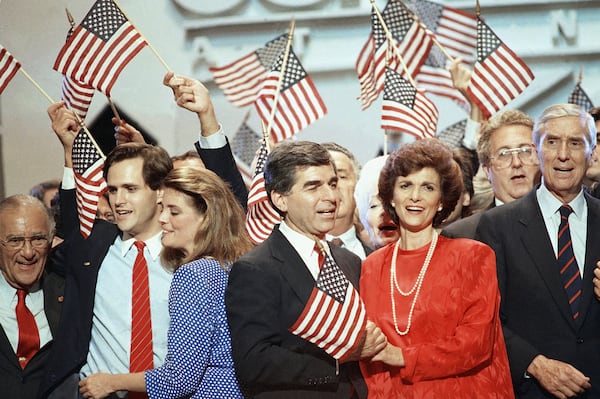 FILE - Gov Michael Dukakis and his wife Kitty wave the American flag as they are cheered by delegates after Dukakis accepted the nomination as the presidential candidate in July 21, 1988 at the Democratic National Convention in Atlanta. (AP Photo/Charles Tasnadi, File)