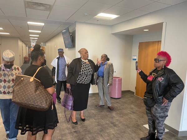 Fulton County Commissioner Khadijah Abdur-Rahman, center, talked with supporters as she leaves court. Photo by Bill Torpy