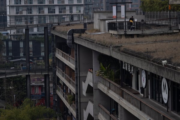 Visitors enjoy the roof top walk way at the West Village project by Pritzker Architecture Prize winner Chinese architect Liu Jiakun in Chengdu in southwestern China's Sichuan province on Sunday, March 2, 2025. (AP Photo/Ng Han Guan)