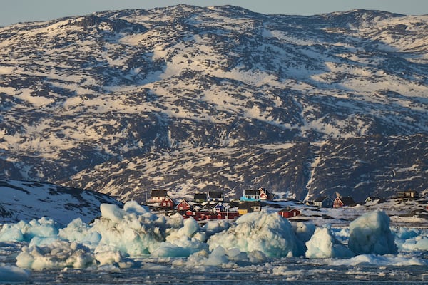 Pieces of ice move through the sea in Qoornoq Island, near Nuuk, Greenland, Monday, Feb. 17, 2025. (AP Photo/Emilio Morenatti)