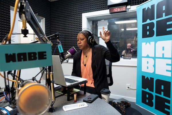 Rose Scott signals as "Closer Look" goes on air in the WABE studio in Atlanta on Monday, Sept. 18, 2023.   (Ben Gray / Ben@BenGray.com)