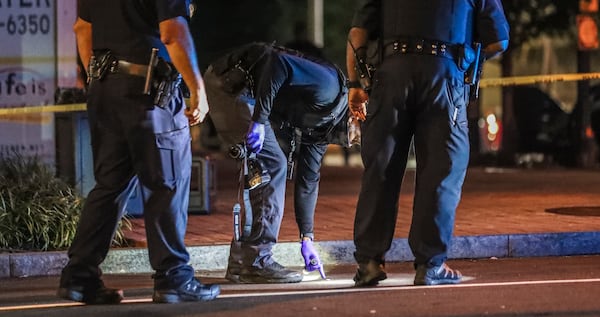 October 7, 2020 Atlanta: Atlanta police investigated the crime scene where a bystander was shot multiple times when someone in a Range Rover opened fire Wednesday morning, Oct. 7, 2020 outside a Midtown nightclub, police said. Officers responding about 5:30 a.m. found the victim outside the Aurum Lounge on Peachtree Place, according to Atlanta police spokesman Officer Steve Avery. “The investigation revealed that a suspect in a dark green Range Rover drove by and fired several shots, missing the intended target and striking the victim,” he said in a statement. “The victim was taken to the hospital in stable condition and the investigation is continuing.” Police did not say if the victim, who was not identified, was a patron of the club. Bullets also shattered the glass storefront of a Supercuts on Spring Street and hit three cars parked nearby. (John Spink / John.Spink@ajc.com)

