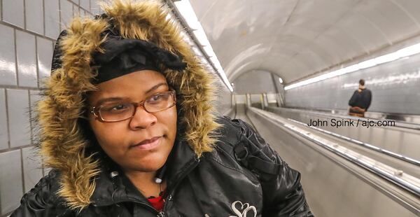 Kenya Williams braves the cold wind blowing through the Peachtree Center MARTA Station escalators Wednesday morning, when temperatures dipped into the low 20s.