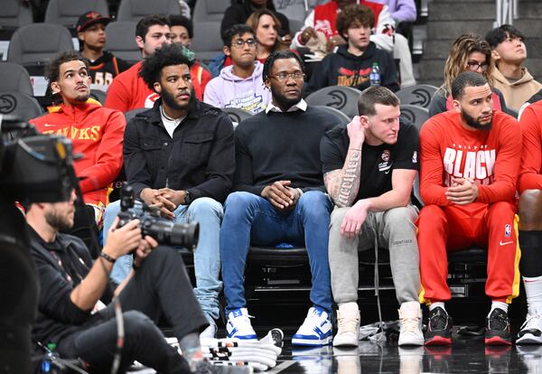 New Hawks players (from left) Saddiq Bey, Bruno Fernando and Garrison Mathews sit on the bench during the first half. (Hyosub Shin / Hyosub.Shin@ajc.com)