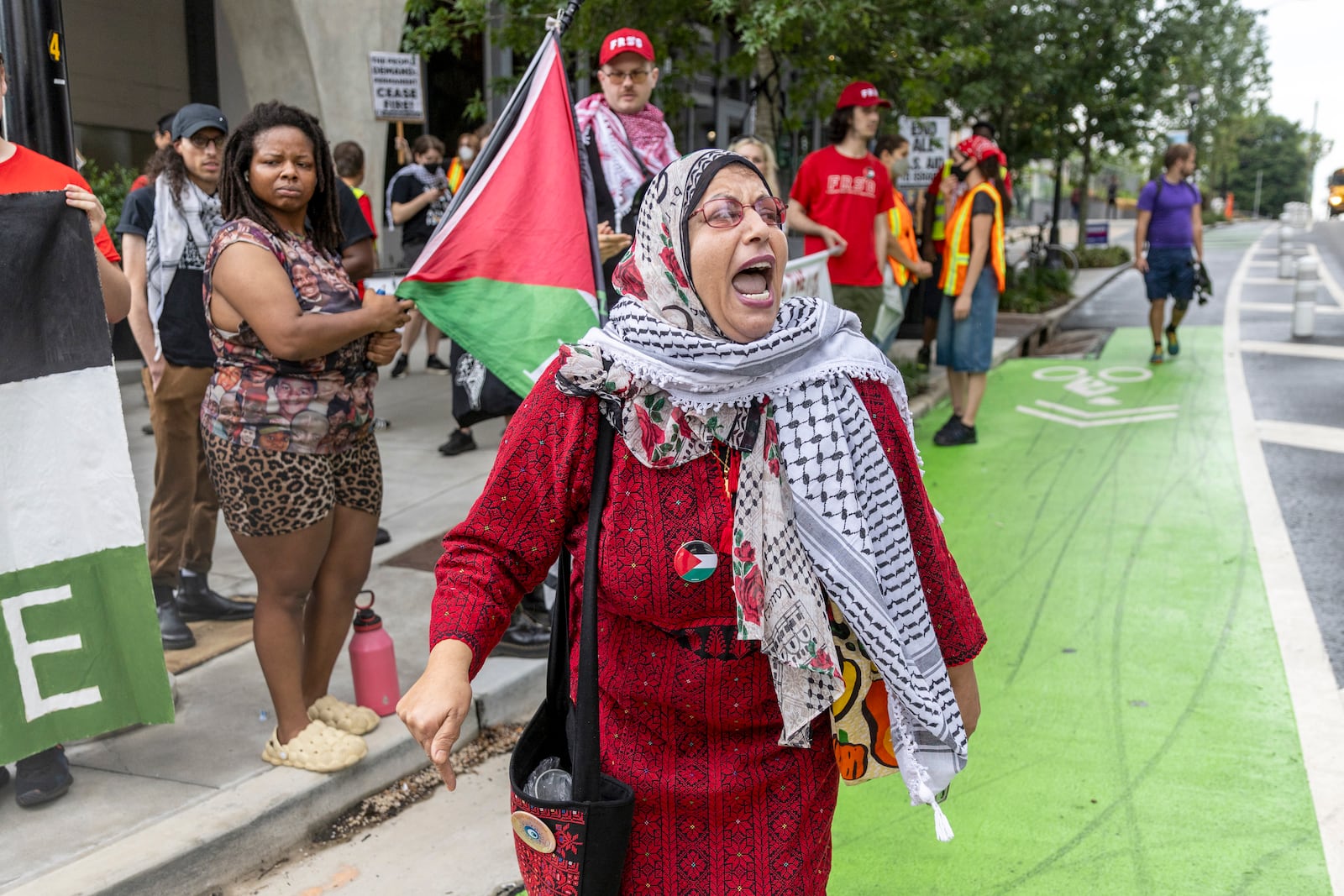 Jawahir Kamil leads the Palestine protester on 10th Street near the Trump/Biden Debate site in Atlanta on Thursday, June 27, 2024. (Steve Schaefer / AJC)