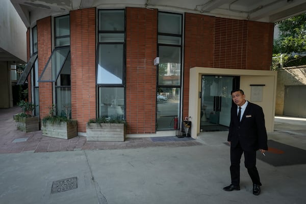 A man stands near what is formerly a branch of the Jiazazhi bookstore in Shanghai, Oct. 10, 2024. (AP Photo/Andy Wong)