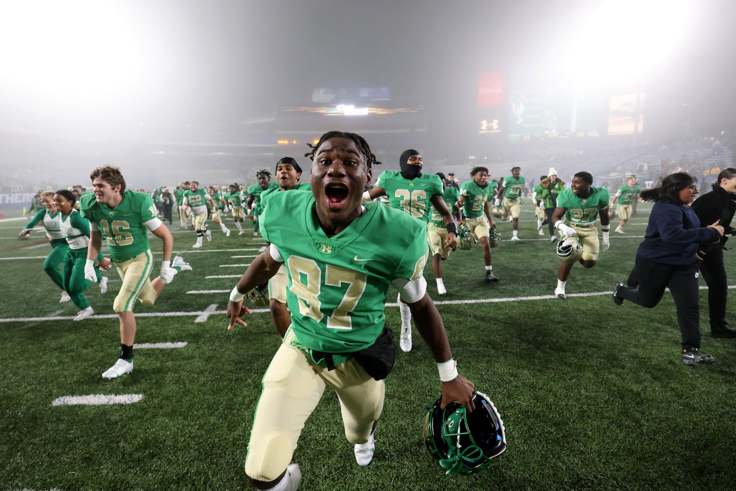 Buford's Javias Robinson (87) and others run toward their student section as they celebrate their 21-20 victory over Langston Hughes during the Class 6A state title football game at Georgia State Center Parc Stadium Friday, December 10, 2021, Atlanta. JASON GETZ FOR THE ATLANTA JOURNAL-CONSTITUTION