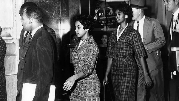 Martin Luther King (left front) and Lonnie King are arrested at Rich’s in Atlanta, Ga. on Oct. 19, 1960.