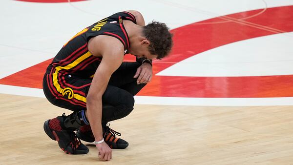 Atlanta Hawks guard Trae Young (11) kneels near the end of the second half of Game 6 of a first-round NBA basketball playoff series against Boston Celtics, Thursday, April 27, 2023, in Atlanta. (AP Photo/Brynn Anderson)