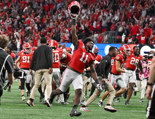 Georgia players celebrate after running back Trevor Etienne scored the game winning touchdown in overtime during the SEC Championship football game at the Mercedes-Benz Stadium, Saturday, December 7, 2024, in Atlanta. Georgia won 22-19 over Texas in overtime. (Hyosub Shin / AJC)