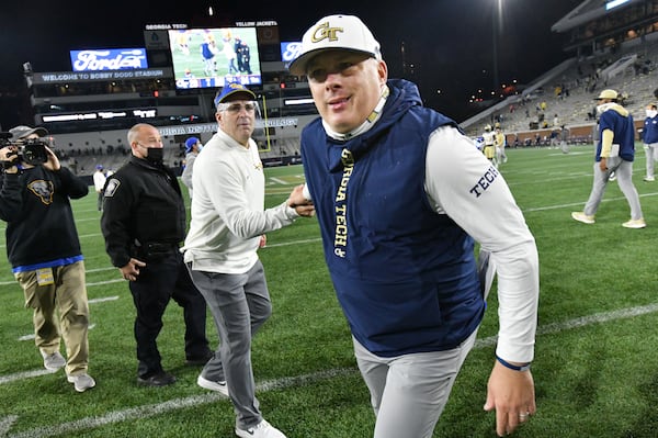 Georgia Tech's coach Geoff Collins and Pittsburgh's coach Pat Narduzzi react after they exchanged an unpleasant handshake after Dec. 10, 2020, game at Bobby Dodd Stadium in Atlanta. Pitt won 34-20. (Hyosub Shin / Hyosub.Shin@ajc.com)