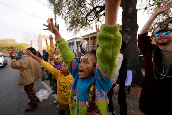 Revelers vie for throws during the Krewe of Zulu parade on Mardi Gras Day, Tuesday, March 4, 2025 in New Orleans. (AP Photo/Gerald Herbert)