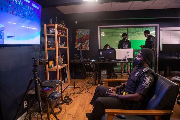 Ralph Coquemar plays a video game against pre-teens and teenagers during Monday's tournament.