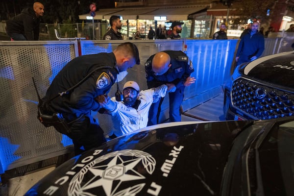 Police disperse people protesting against Prime Minister Benjamin Netanyahu's near his residence in Jerusalem, after he has dismissed his defense minister Yoav Gallant in a surprise announcement Tuesday, Nov. 5, 2024. (AP Photo/Ohad Zwigenberg)