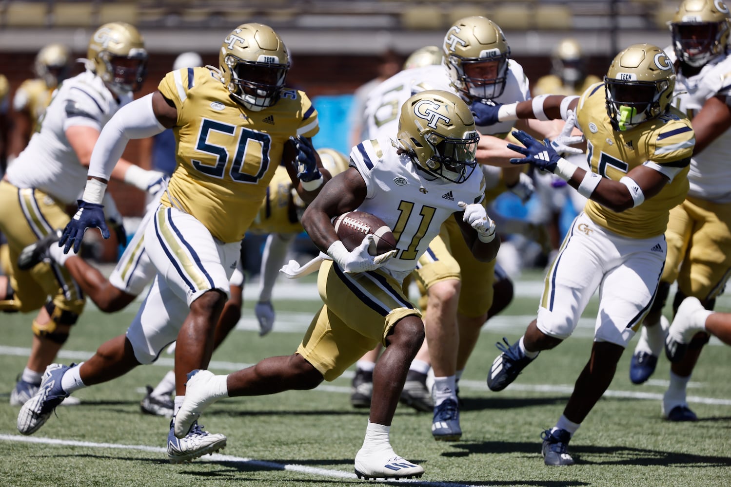 Georgia Tech running back Jamal Haynes (11) takes off ahead of Georgia Tech defensive lineman Ayo Tifase (50) in the first quarter during the Spring White and Gold game at Bobby Dodd Stadium at Hyundai Field In Atlanta on Saturday, April 13, 2024.   (Bob Andres for the Atlanta Journal Constitution)