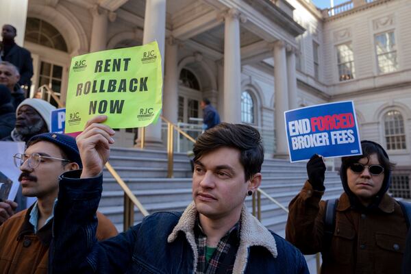 People gather outside of City Hall for a rally in support of the FARE Act ahead of a City Council meeting, Wednesday, Nov. 13, 2024, in New York. (AP Photo/Adam Gray)