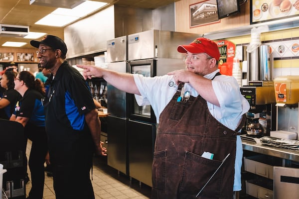 Atlanta chef Chris Hall is a fan of Waffle House, and is seen here cooking at the location on Piedmont Road in Buckhead for a charity event. (Courtesy of William Brawley)