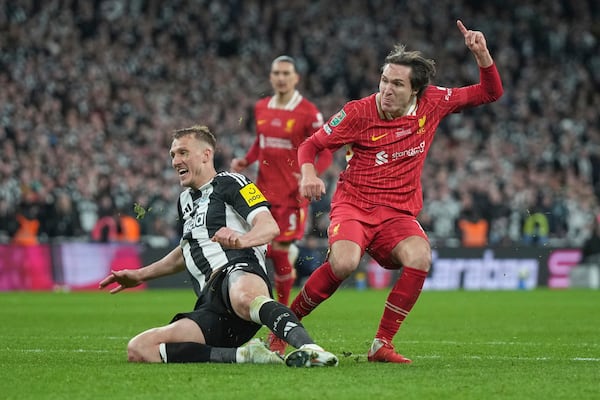 Liverpool's Federico Chiesa, right, scores his side's opening goal during the EFL Cup final soccer match between Liverpool and Newcastle at Wembley Stadium in London, Sunday, March 16, 2025. (AP Photo/Alastair Grant)