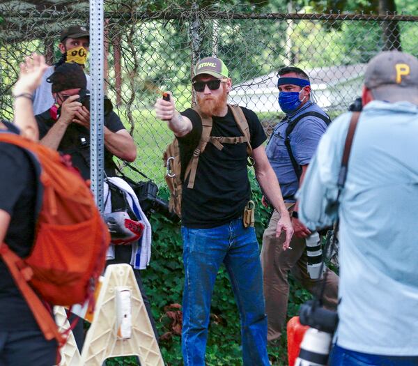 8/15/20 - Stone Mountain, GA - A far-right protestor aims pepper spray toward counter protestors as several far-right groups, including militias and white supremacists, rally Saturday in the town of Stone Mountain, and a broad coalition of leftist anti-racist groups organized a counter-demonstration there after local authorities closed Stone Mountain park.  Steve Schaefer for the Atlanta Journal Constitution