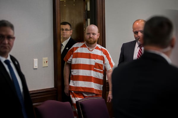 Travis McMichael smiles at his mother as he returns to the courtroom during short break in a hearing challenging his trial, Thursday, Oct. 24, 2024, in Brunswick, Ga. (AP Photo/Stephen B. Morton)