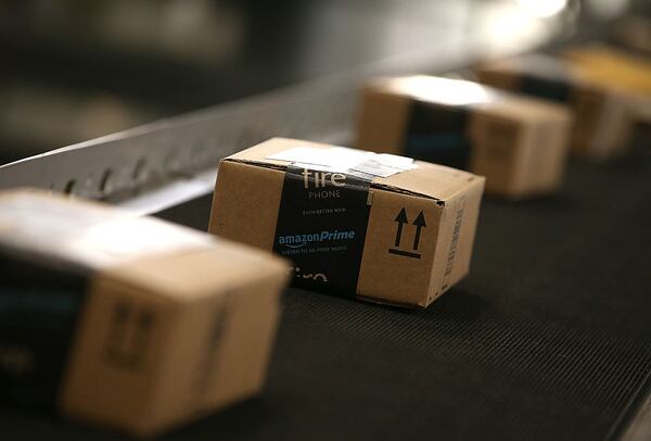 Boxes move along a conveyor belt at an Amazon fulfillment center on January 20, 2015 in Tracy, California. (Photo by Justin Sullivan/Getty Images)