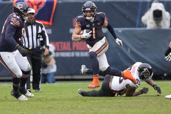 Bears quarterback Justin Fields (1) breaks away in the second half of a game against the Falcons in Chicago, Sunday, Dec. 31, 2023. (AP Photo/Charles Rex Arbogast)