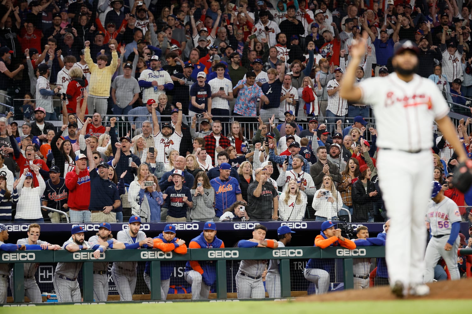 Braves fans react after relief pitcher Kenley Jansen recorded a strikeout for the final out in a 4-2 win over the New York Mets for the second game of the series at Truist Park on Saturday, Oct. 1, 2022. Miguel Martinez / miguel.martinezjimenez@ajc.com 