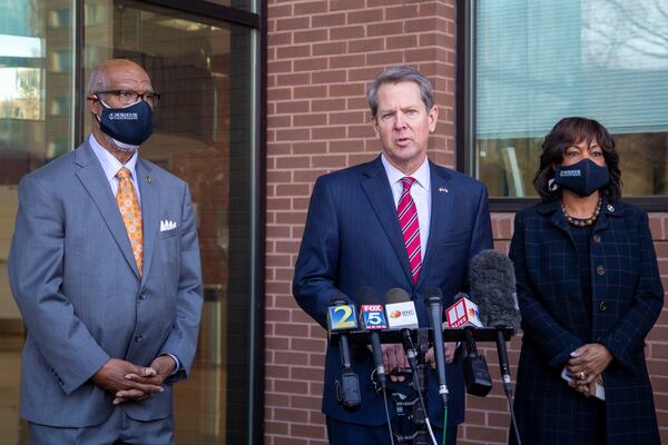  Georgia's dean of the House of Representatives, Rep. Calvin Smyre (D-Columbus), left, and Morehouse School of Medicine President Dr. Valeria Montgomery Rice, right, listen as Gov. Brian Kemp speaks during a press conference at Morehouse School of Medicine in Atlanta. (Alyssa Pointer / Alyssa.Pointer@ajc.com)