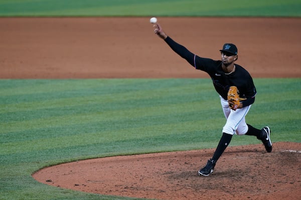 FILE - Miami Marlins' Johan Quezada pitches during a baseball game against the Philadelphia Phillies, in Miami, Sept. 12, 2020. Like other Dominican baseball players, Quezada felt pressure to perform while young: "We have to have baseball for breakfast, lunch and dinner if we want to get anywhere." (AP Photo/Wilfredo Lee, File)