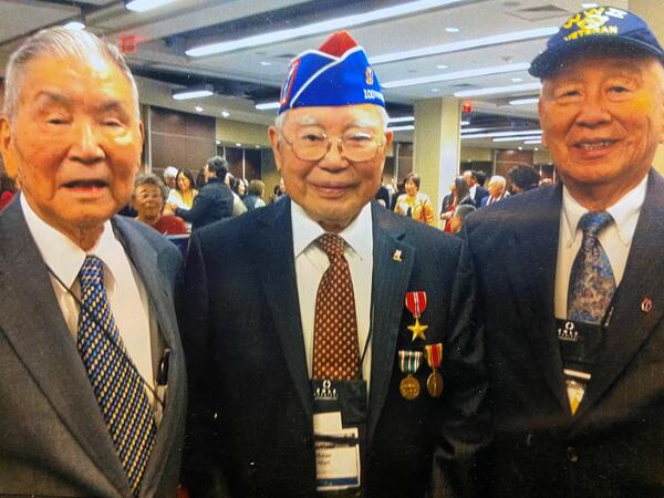 Jimmy Doi (right) and his older brother Michael Doi (left) celebrate with a fellow member of the 442nd Regimental Combat Team (center) in 2010, when the 442nd was given the Congressional Gold Medal. Photo: Janice Sears