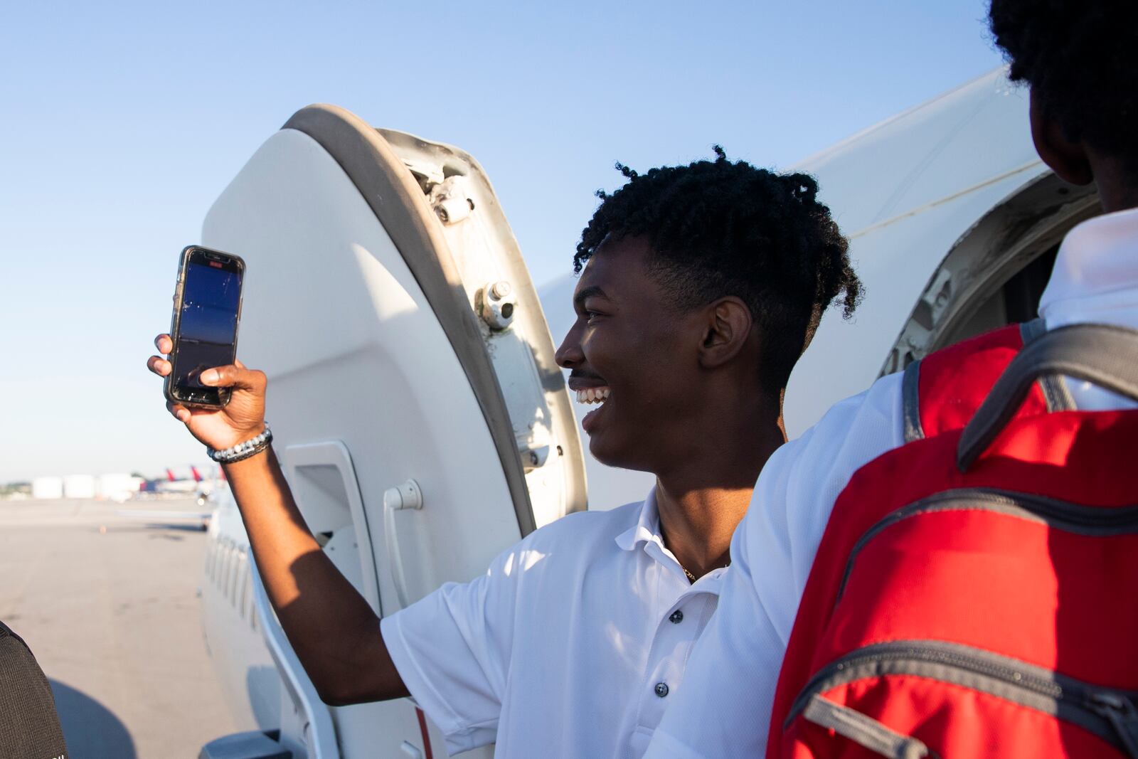 A participant of Delta’s Dream Flight 2022 records the runway before boarding a plane at Hartsfield-Jackson Atlanta International Airport on Friday, July 15, 2022. Around 150 students ranging from 13 to 18 years old will fly from Atlanta to the Duluth Air National Guard Base in Duluth, Minnesota. (Chris Day/Christopher.Day@ajc.com)