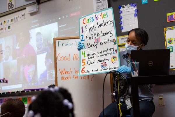 Ms. Micahiah Drake holds up the class rules at Liberty Point Elementary School in Union City, Georgia, on Friday, October 16, 2020. Ms. Micahiah Drake is a first-year Pre-K techer at Liberty Point Elementary School and has had to adjust her teaching style because of the coronavirus pandemic. (Rebecca Wright for the Atlanta Journal-Constitution)