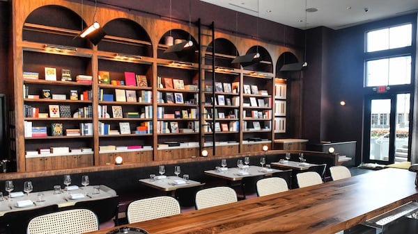 “It’s been really wonderful to see how many people come in for food and wine, and then after looking at the bookshelves during their meal, they end up on that side, and take home books,” said Lucian Books and Wine co-owner Katie Barringer, who was the founder of Cover Books. (Chris Hunt for The Atlanta Journal-Constitution)