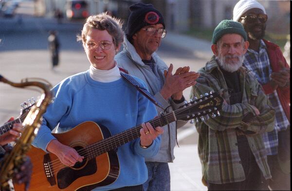 Murphy Davis leads a gathering in song outside of the Atlanta City Detention Center where they had gathered for a worship service. Behind her (left to right) Ralph Dukes, Ed Potts and Tony Johnson. (AJC Photo/Jonathan Davis)